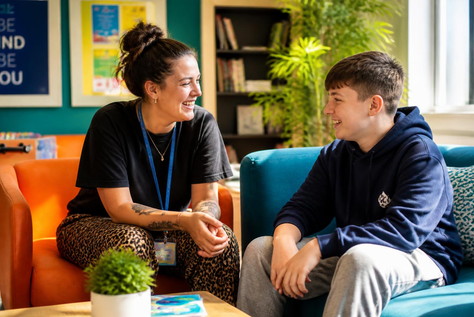 A support worker talking with a young person at home
